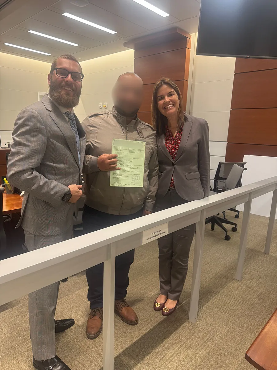 A team standing together with a man in the middle.