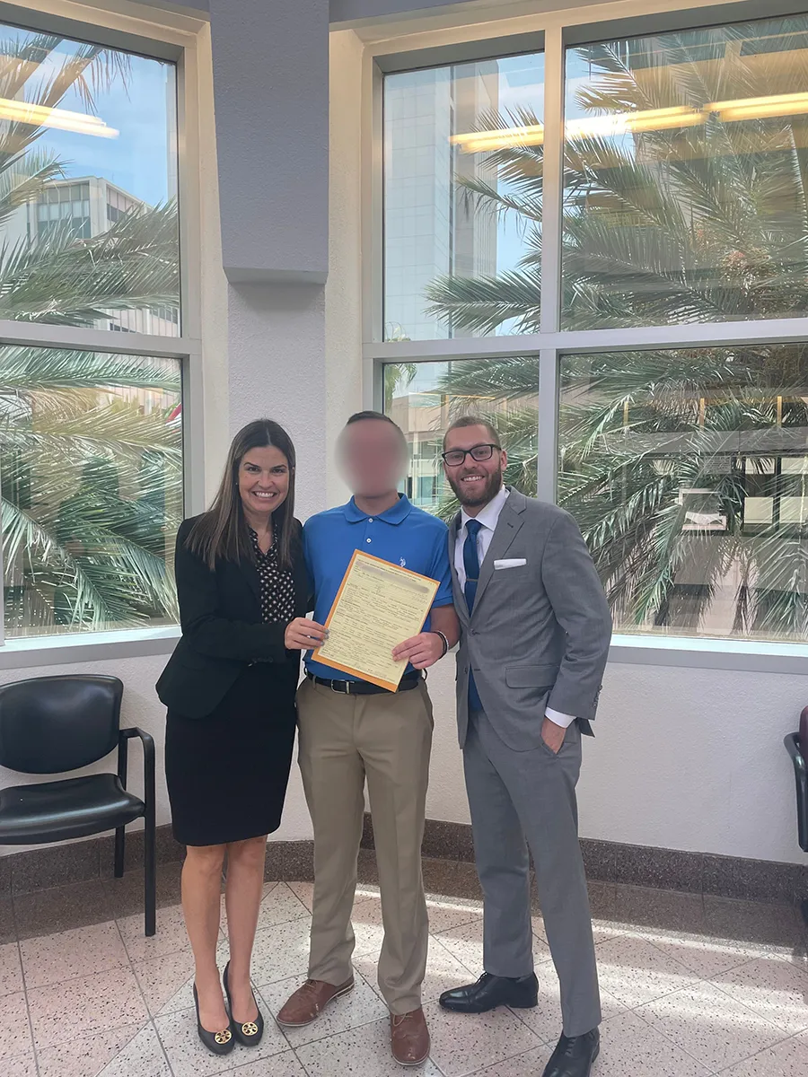 A team standing together with a man in the middle.