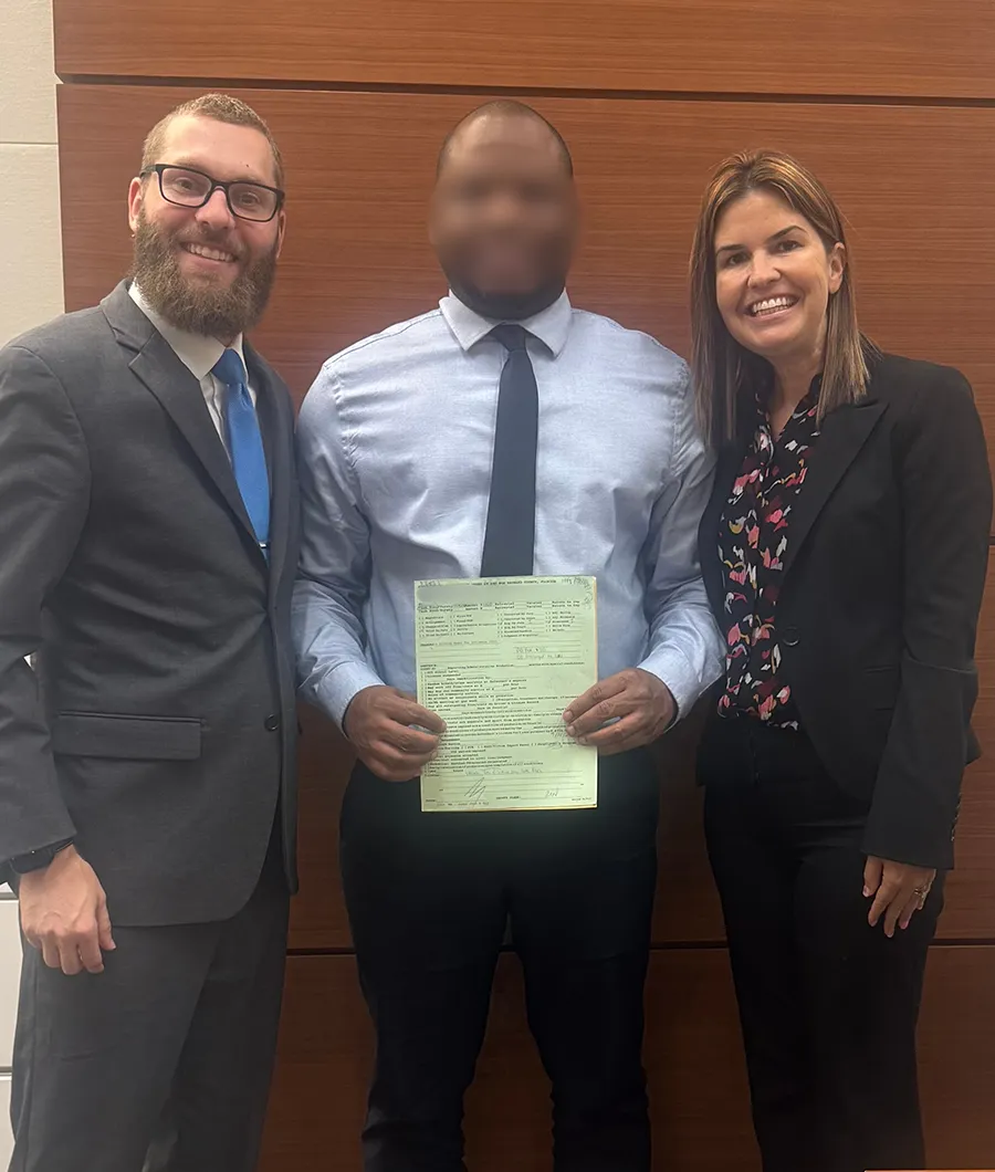 A team standing together with a man in the middle