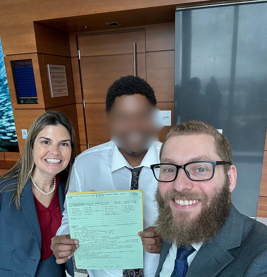 A team standing together with a man in the middle