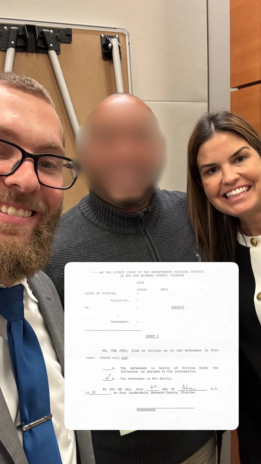 A team standing together with a man in the middle